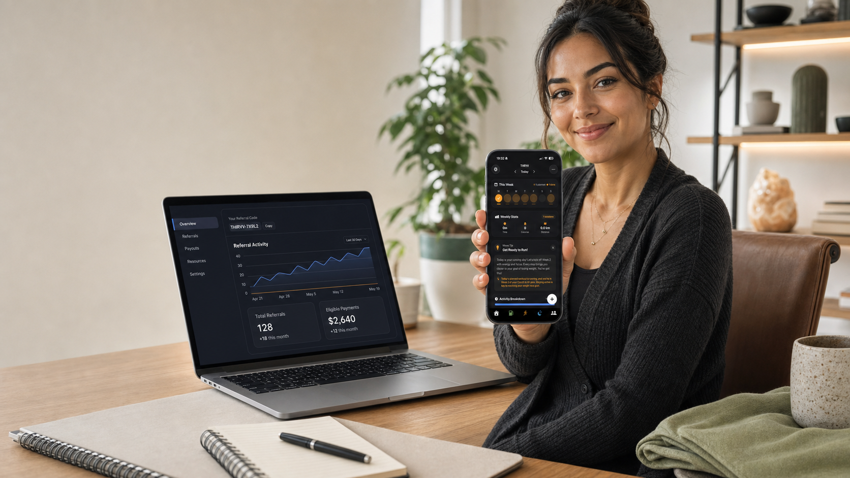 THRYV affiliate using the platform on a phone and laptop while managing referrals